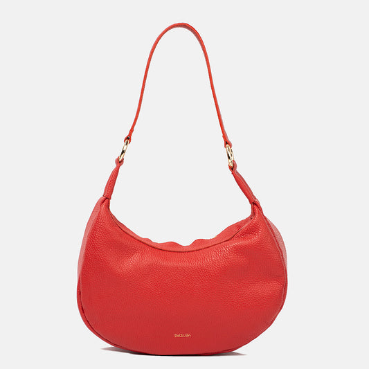 Profile view of the red Hedera bag showcasing its grainy leather texture and elegant design