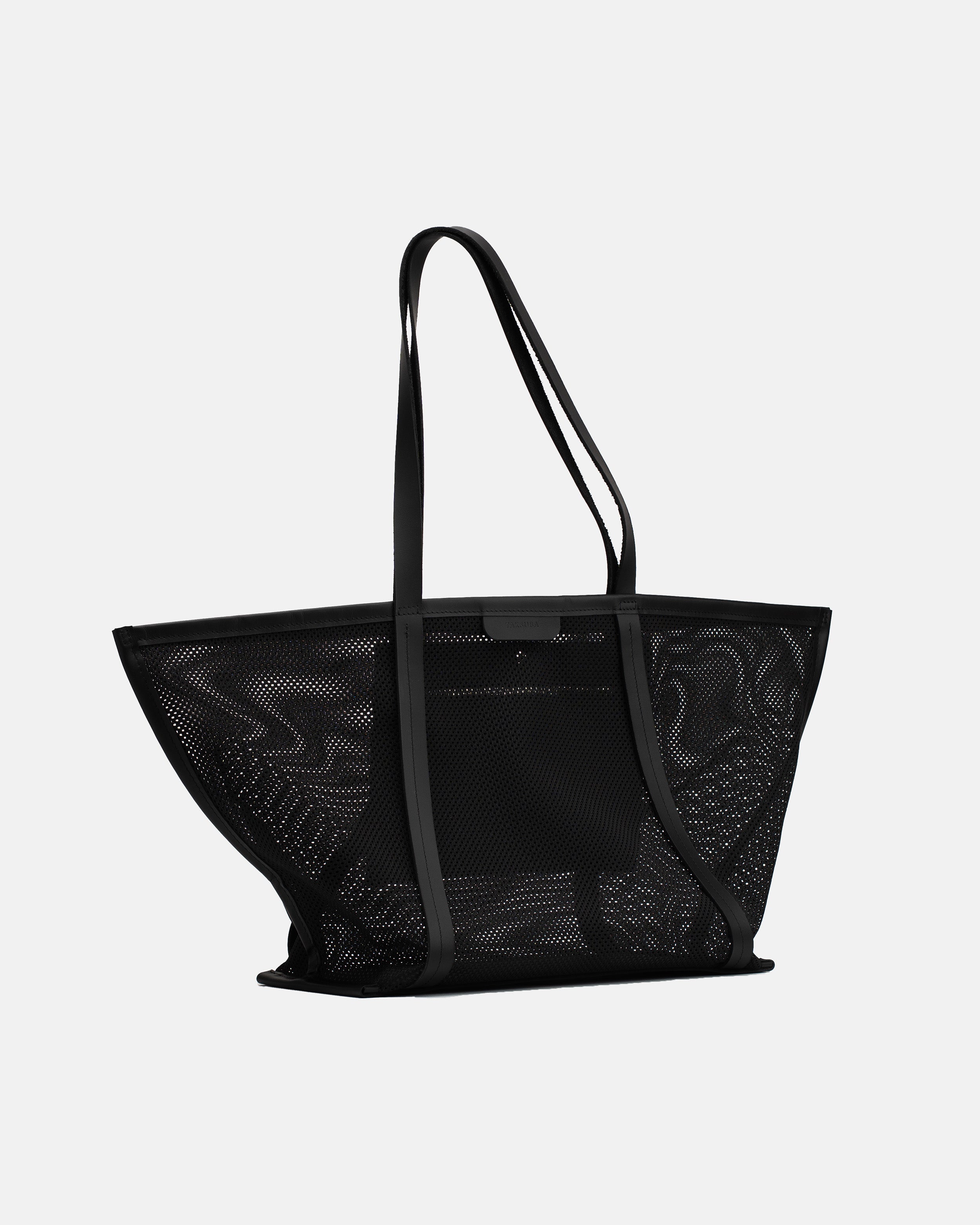 Angled view of the black Astra Mesh shopper bag with long shoulder handles and structured mesh body