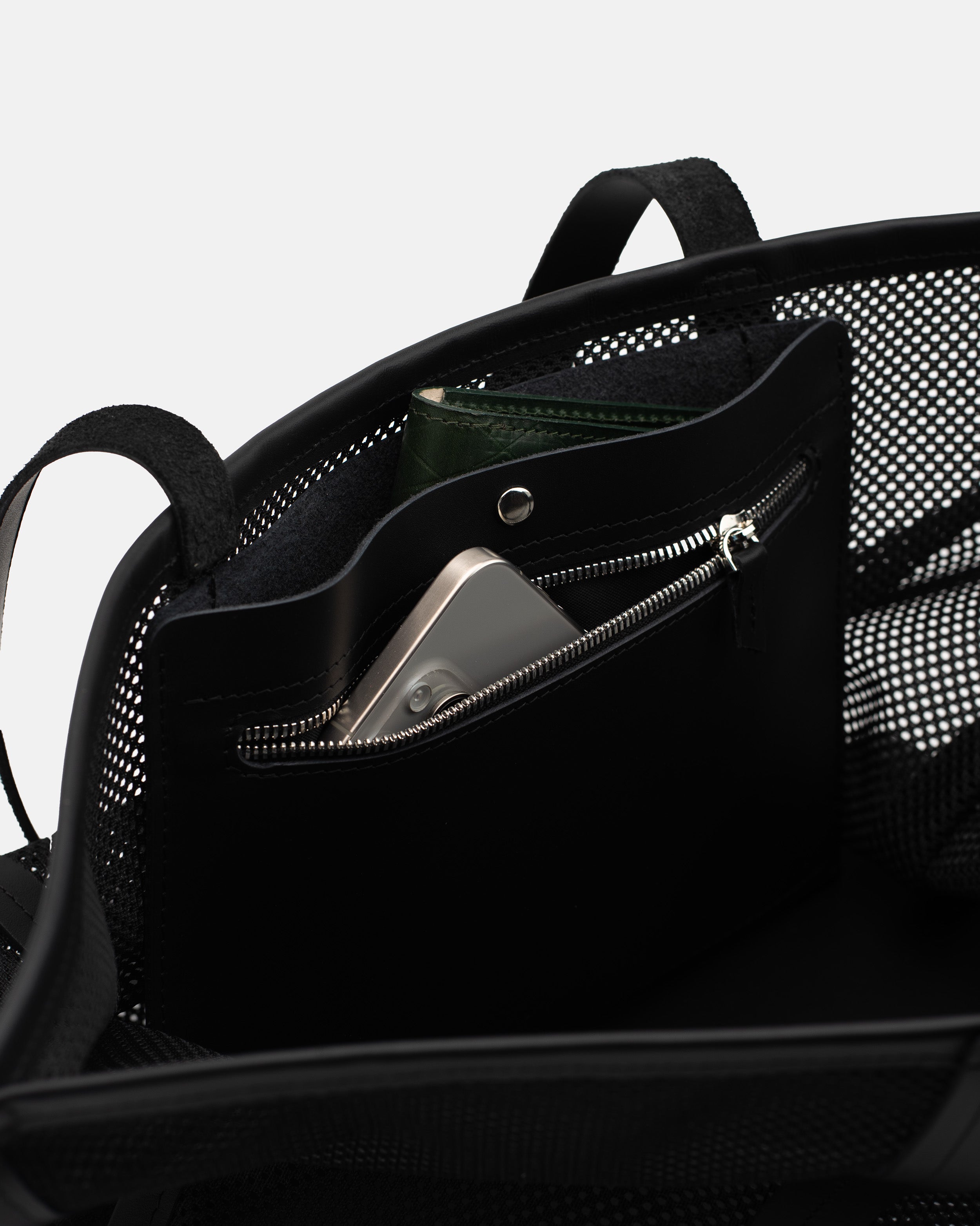 Close-up of the Astra Mesh shopper interior with zip pocket for phone, wallet, and small essentials