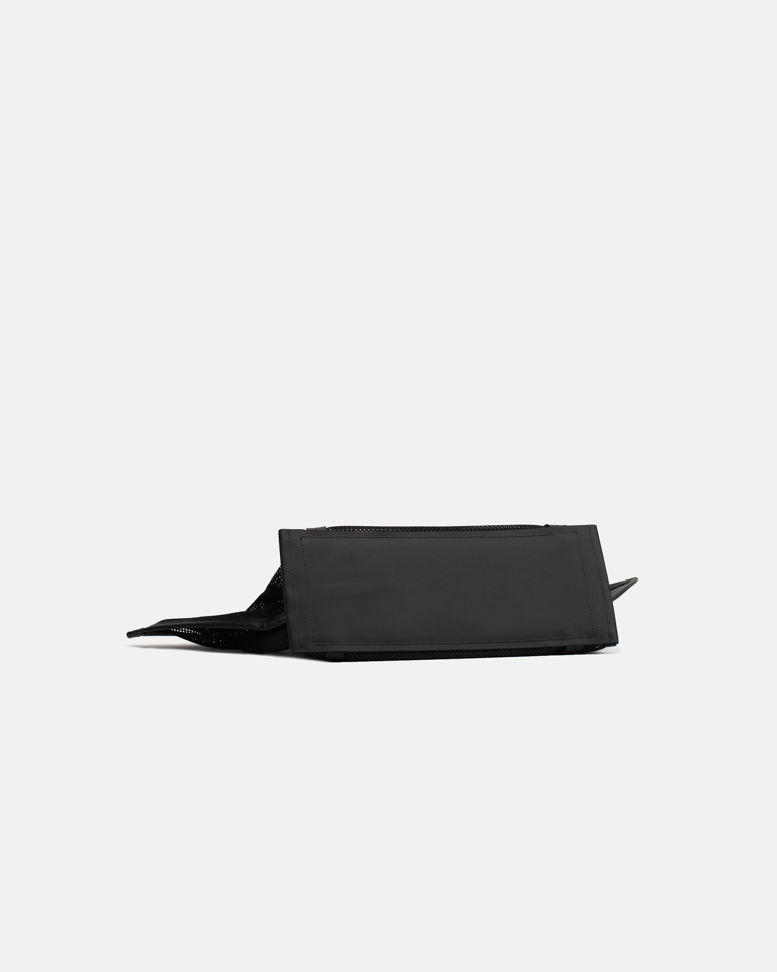 Low side view of the black Astra Mesh shopper bag showing the flat structured leather base