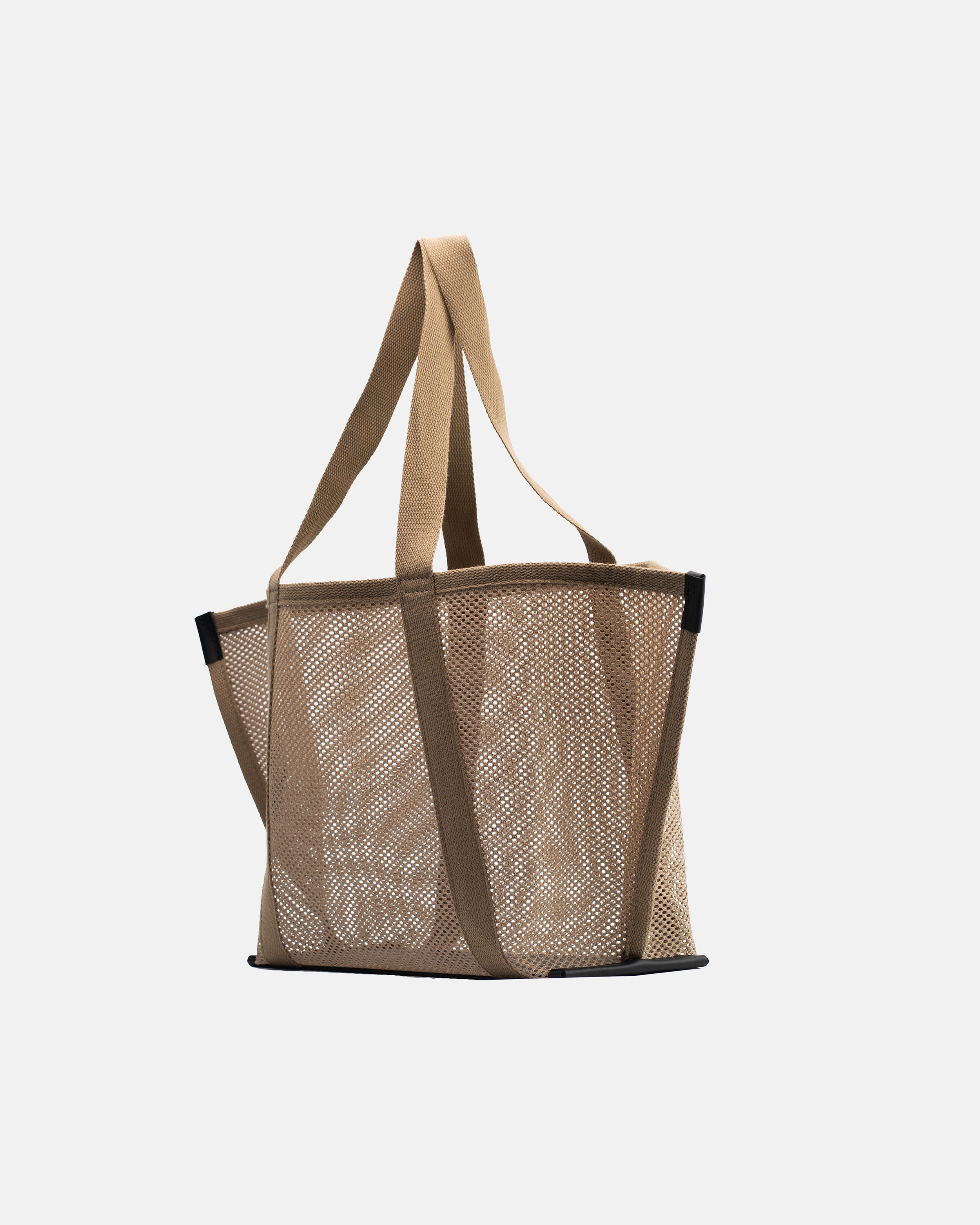 Angled front view of Astra Shopper Mesh beige tote bag with semi-transparent mesh body, long shoulder straps, and structured base