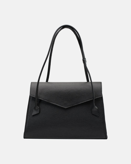 Black pebbled leather shoulder bag with structured trapezoid silhouette, pointed envelope flap and long double handles, front view.
