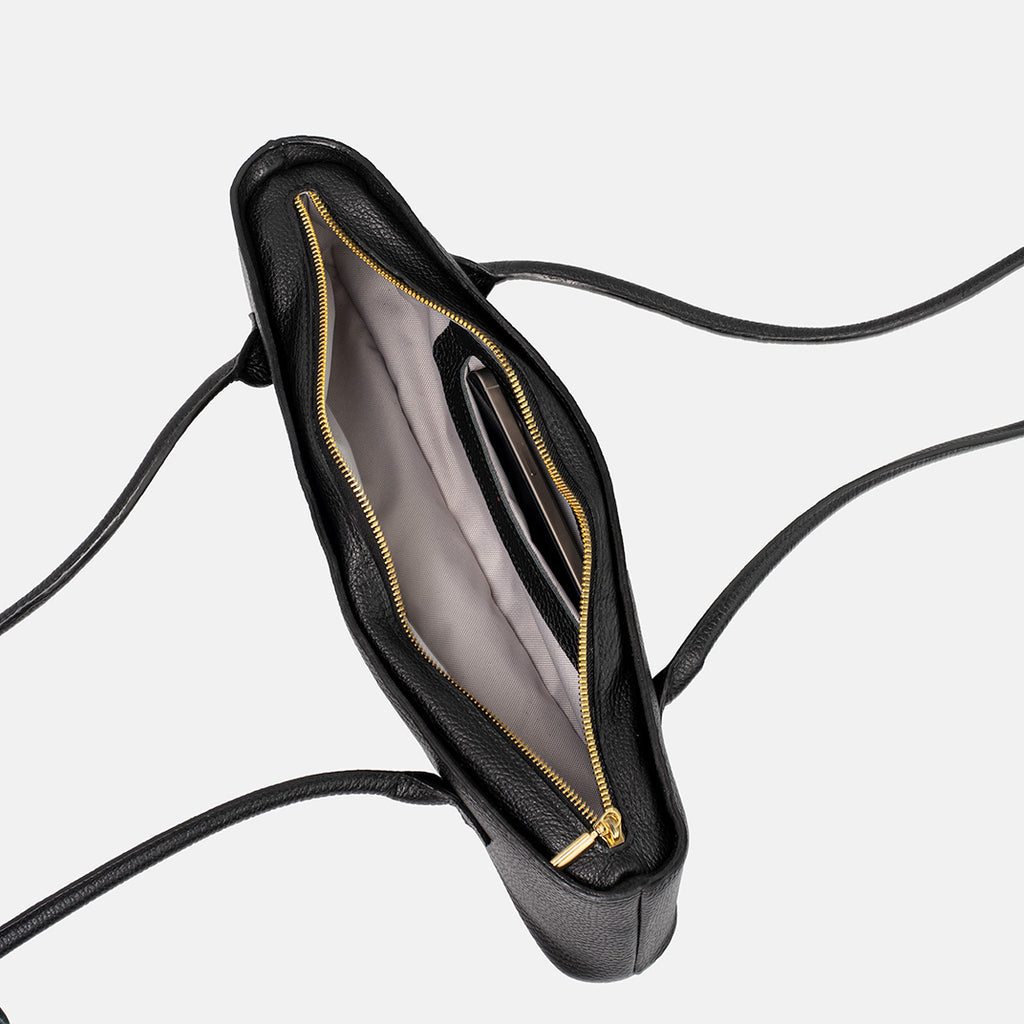 Interior of the black Teckelete leather handbag with inner pocket and textured leather