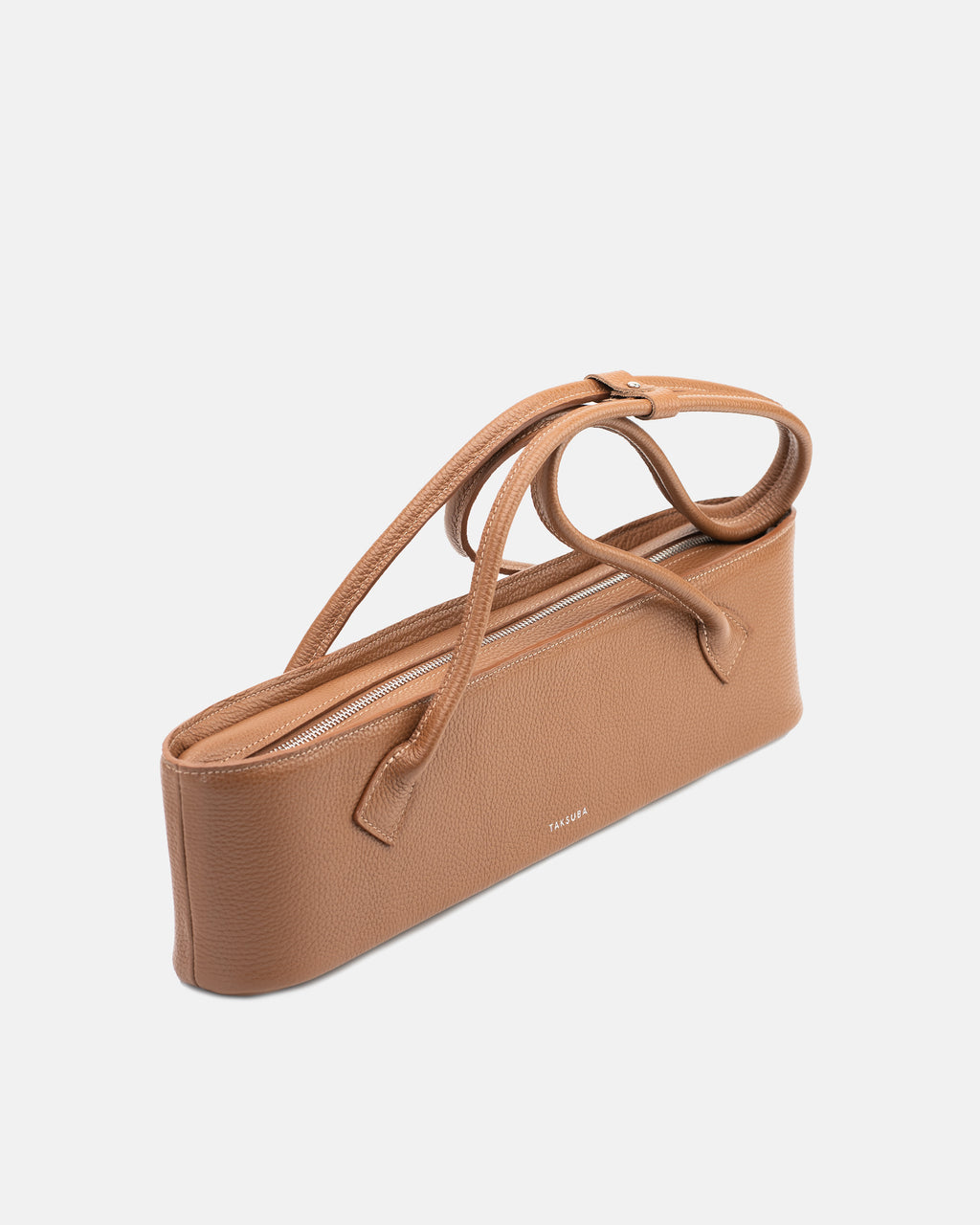 Brown Teckelete leather handbag showing its slim horizontal profile