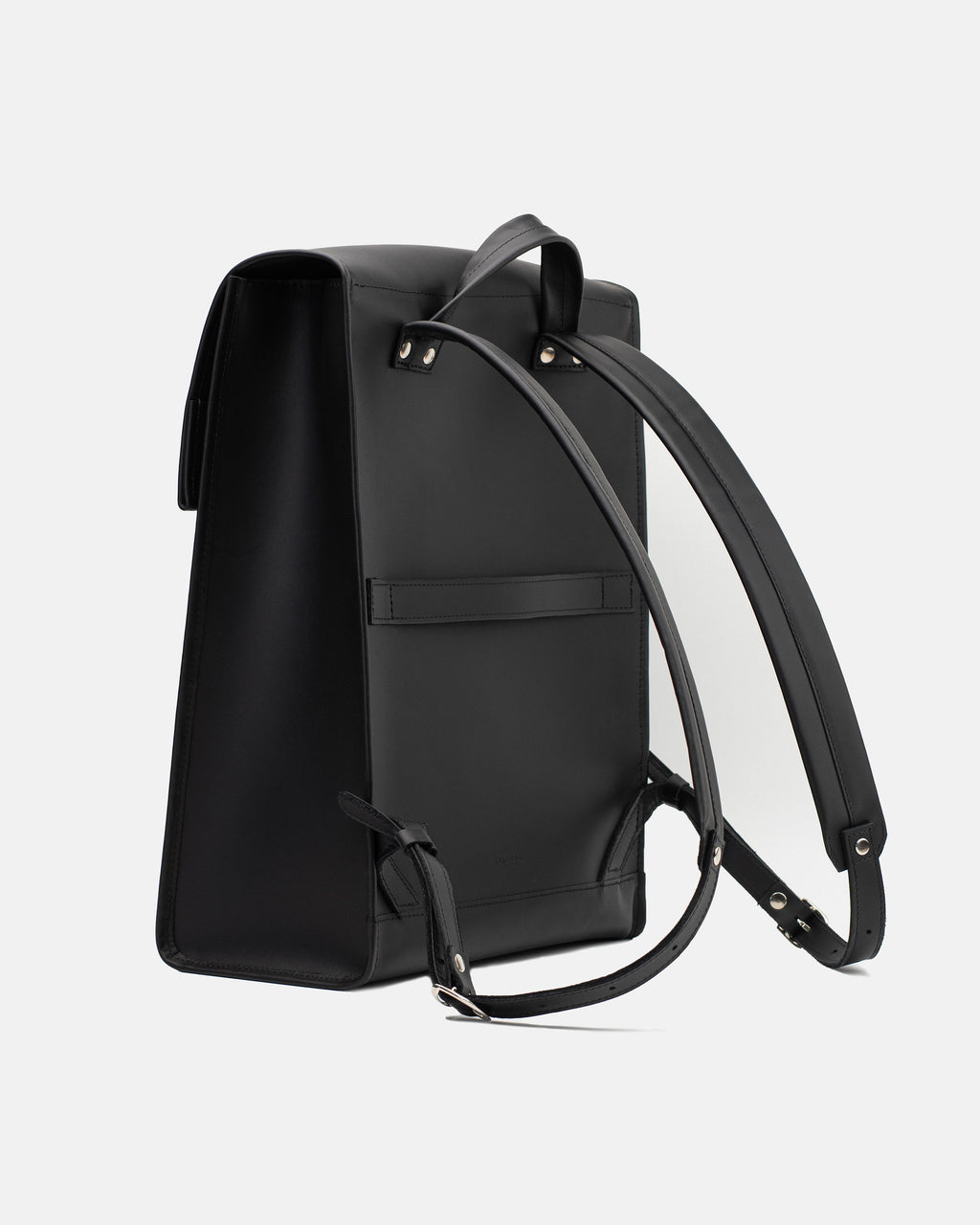 Rear view of the large black leather backpack with shoulder straps and horizontal luggage strap