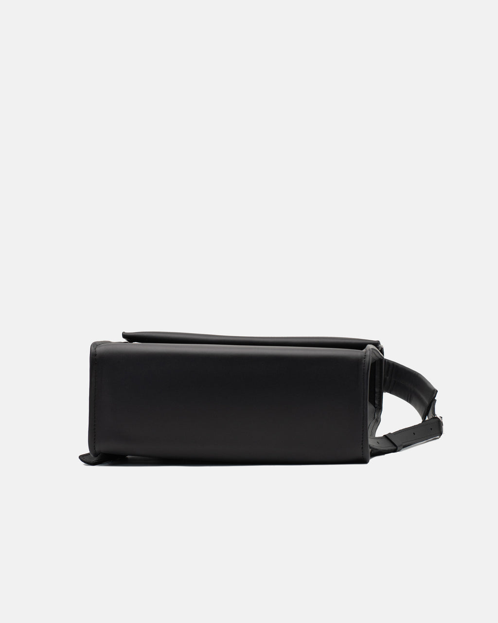 Side view of the large black leather backpack showing its structured depth and folded top flap