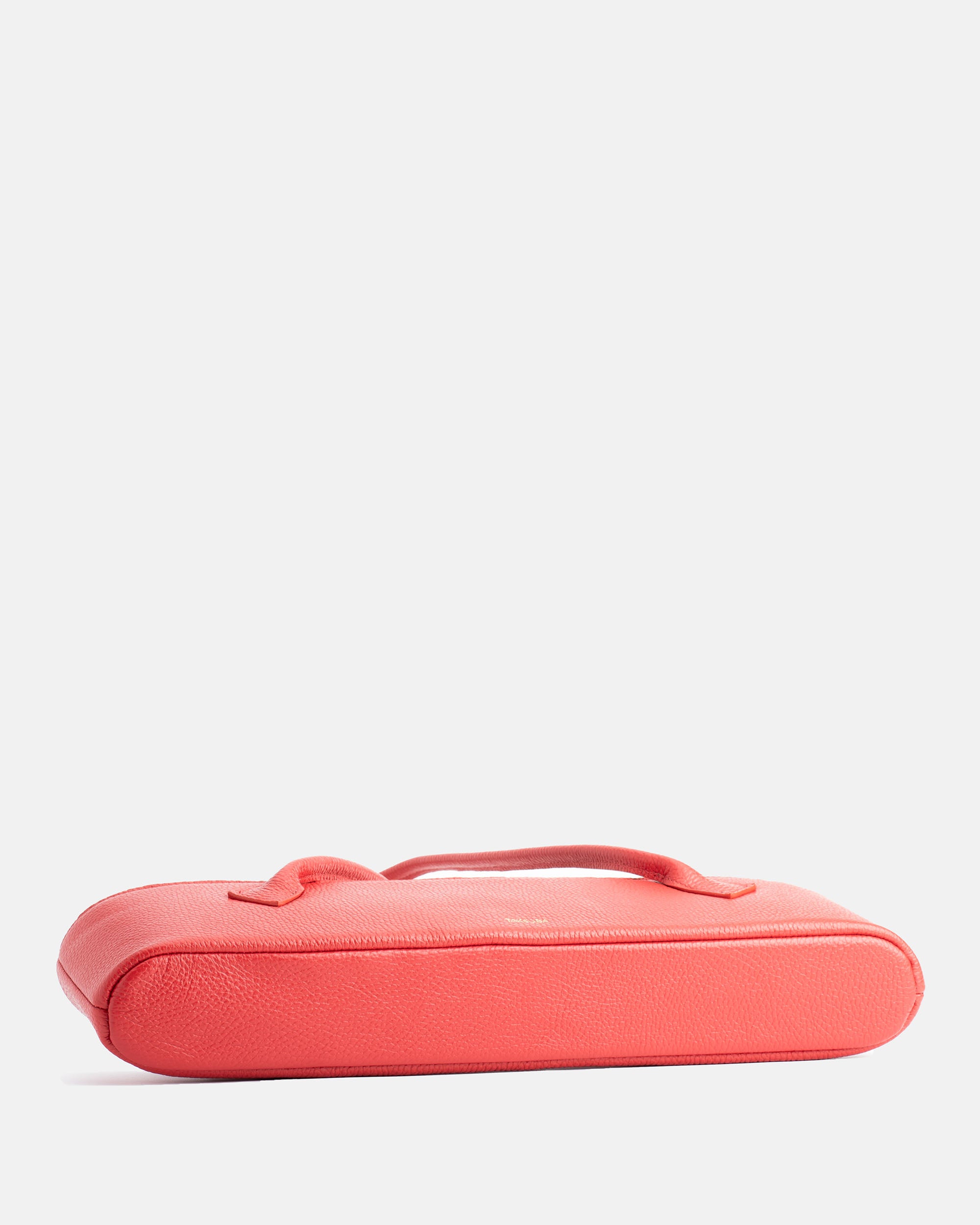 Side view of the red Teckelete leather handbag with textured leather