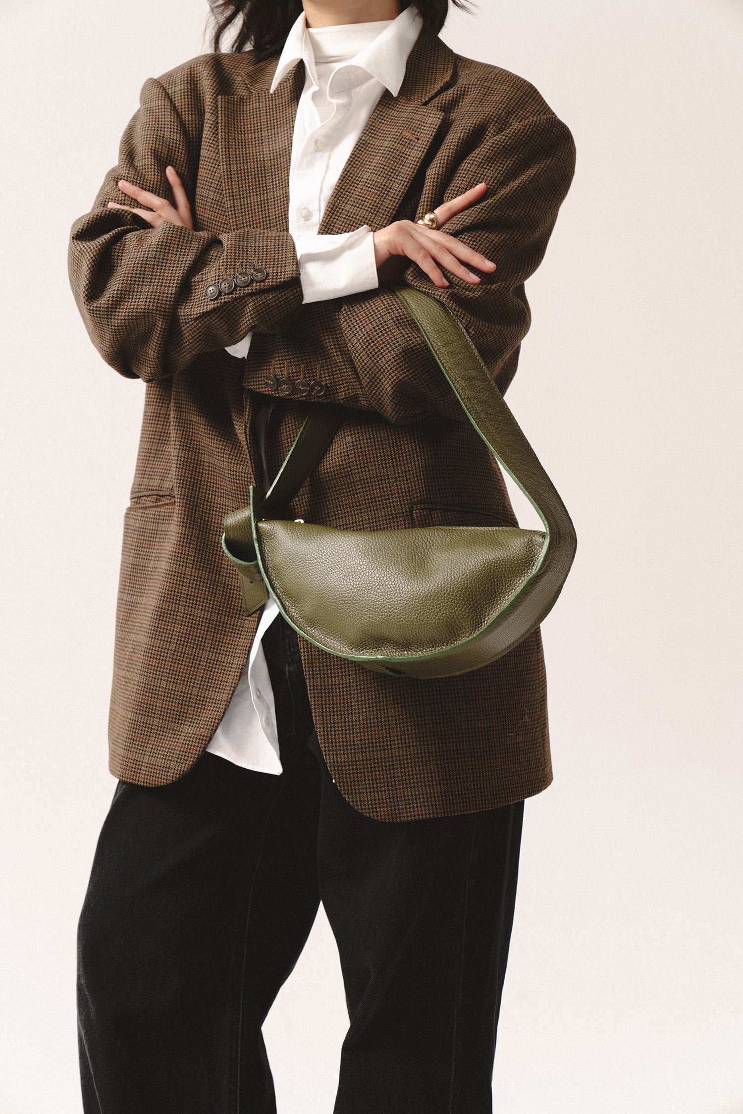 torebka skórzana damska oliwkowa Eclipse M – olive green leather crescent bag with wide strap and magnetic closure, close-up view on textured finish